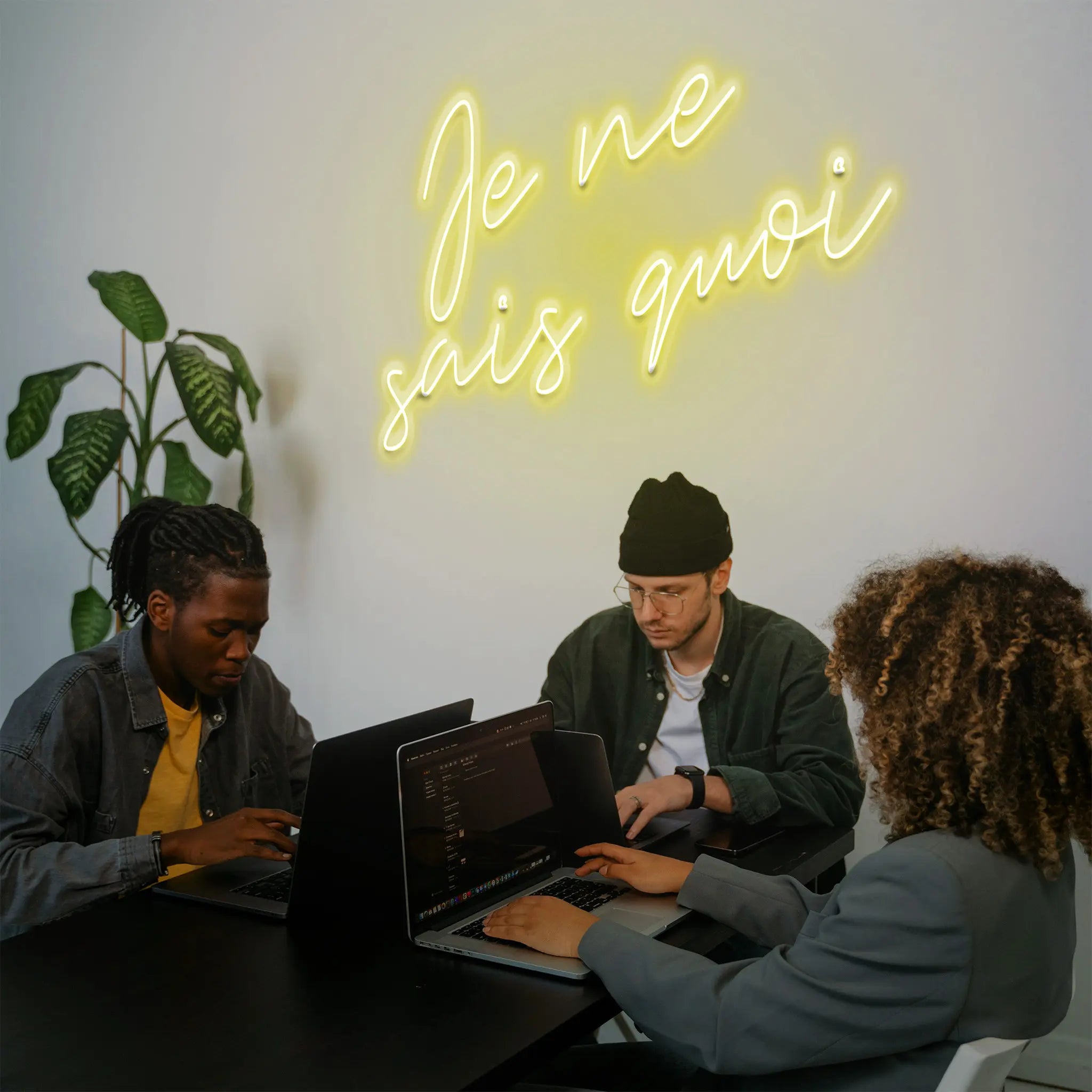 Close-up of the Je Ne Sais Quoi Neon Sign, glowing with a chic, elegant design that represents a certain charm and mystery.