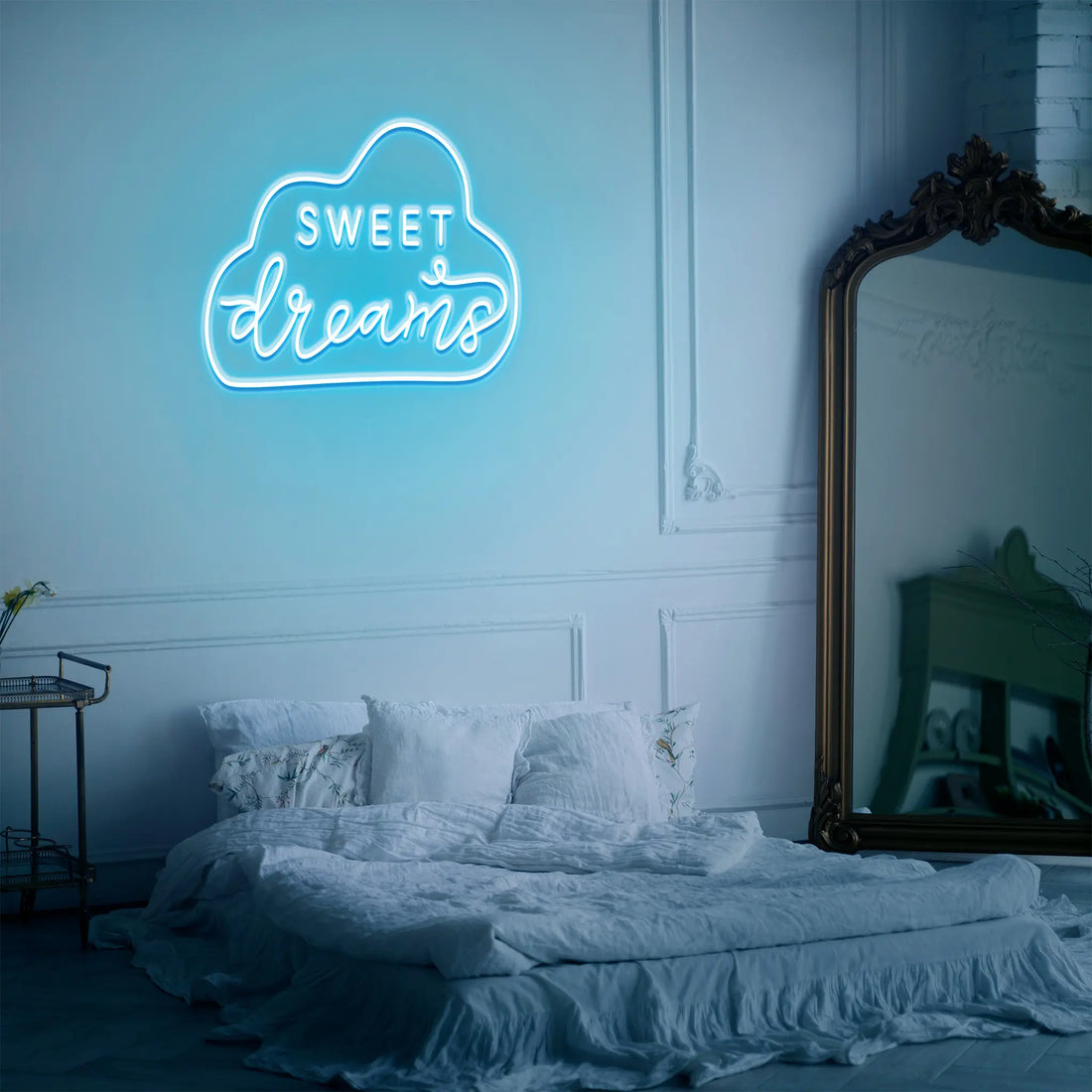 "Sweet Dreams Neon Sign glowing softly in a cozy bedroom setting."