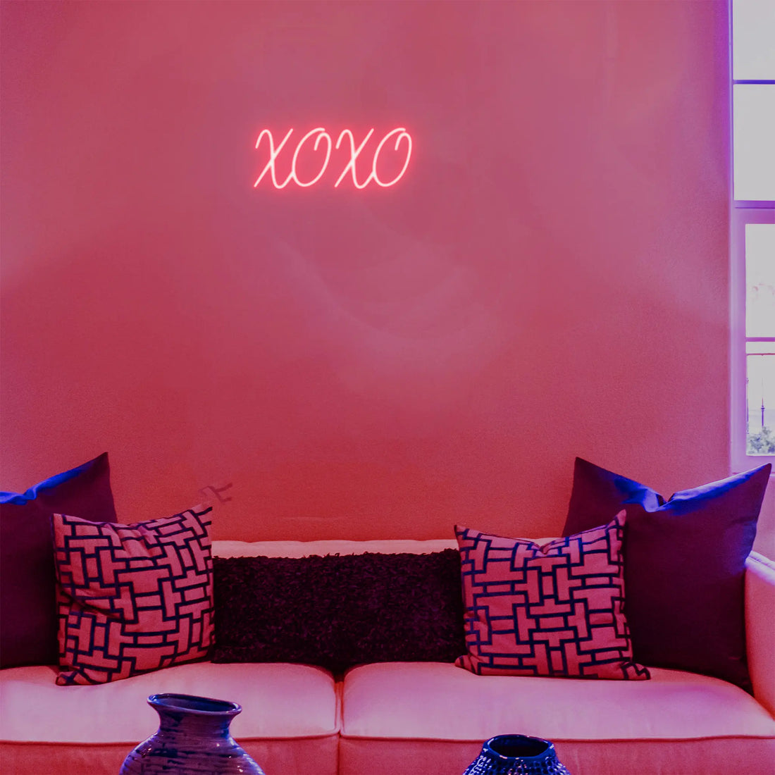 XOXO neon sign mounted on a wall, perfect for a cozy ambiance in bedrooms, cafes, or businesses.